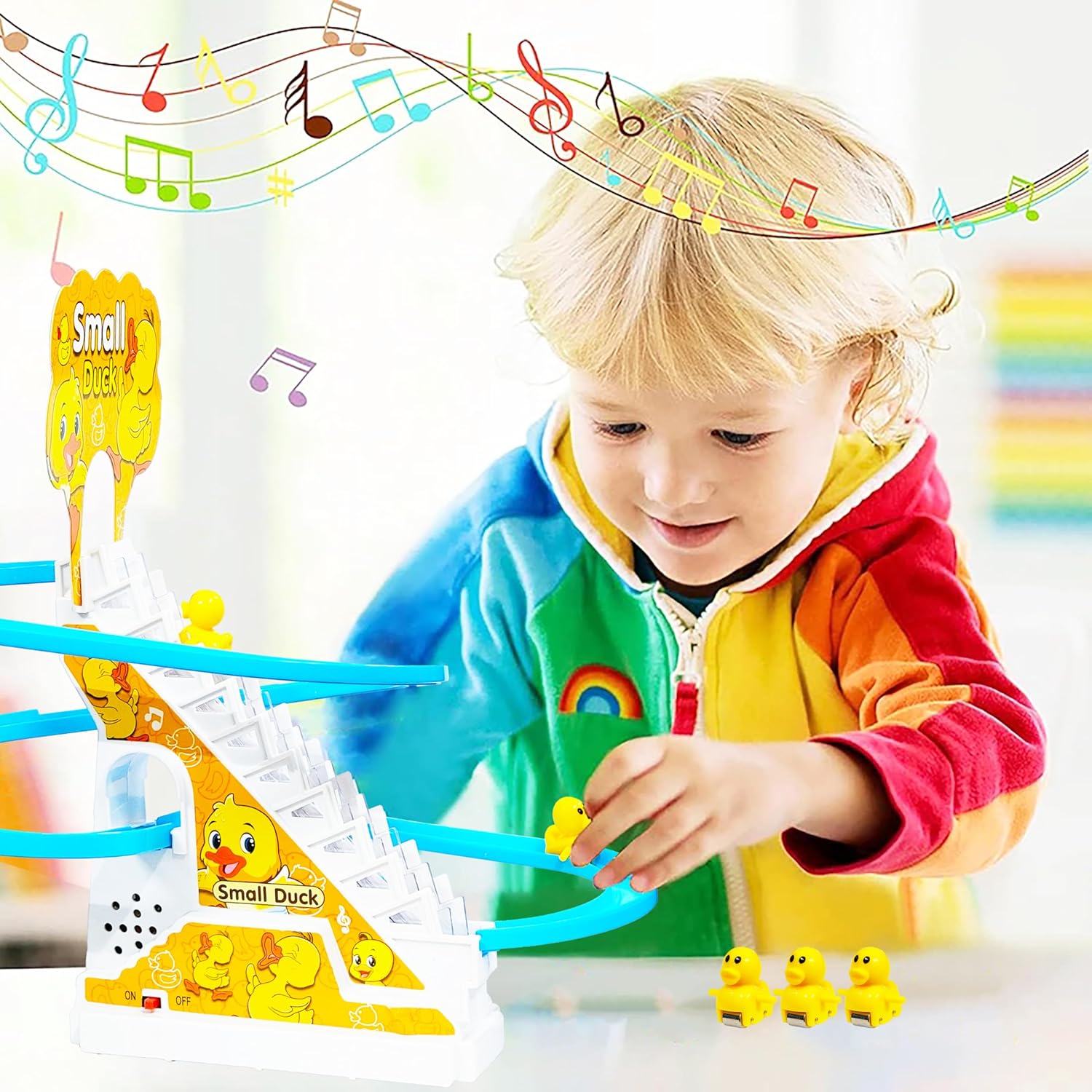 Child playing with a colorful toy track featuring small duck figures.